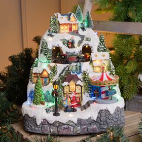 Pueblo de Navidad nevado con Trenecito, Árbol y Tiovivo giratorios, h 31 cm, villancicos