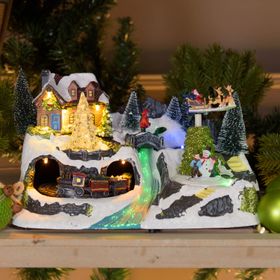 Villaggio di Natale con Paesaggio Innevato, Trenino e Babbo su Slitta rotanti, Ruscello fibre ottiche, h 18 cm, musiche natalizie