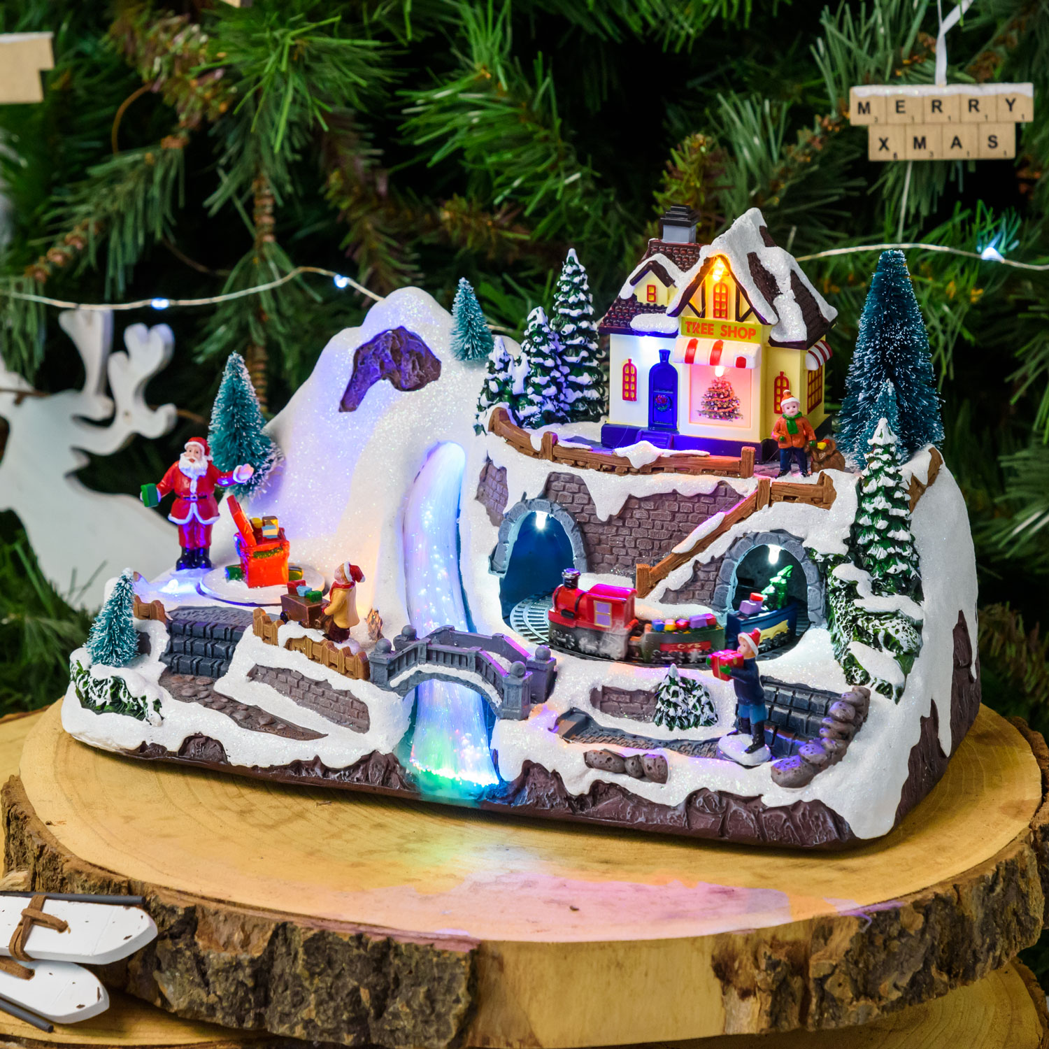Polyresin Christmas Village, Train in Tunner and Rotating Gift Boxes, h 19 cm, with Christmas Music Polyresin Christmas Village, Train in Tunner and Rotating Gift Boxes, h 19 cm, with Christmas Music